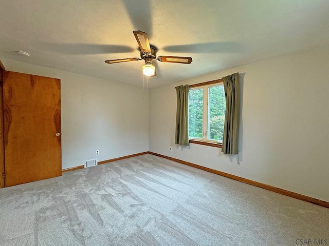 unfurnished room featuring light carpet and ceiling fan