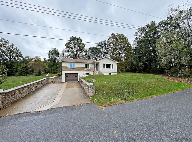 bi-level home featuring a garage and a front lawn