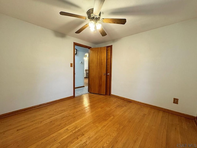 unfurnished room with ceiling fan and light wood-type flooring