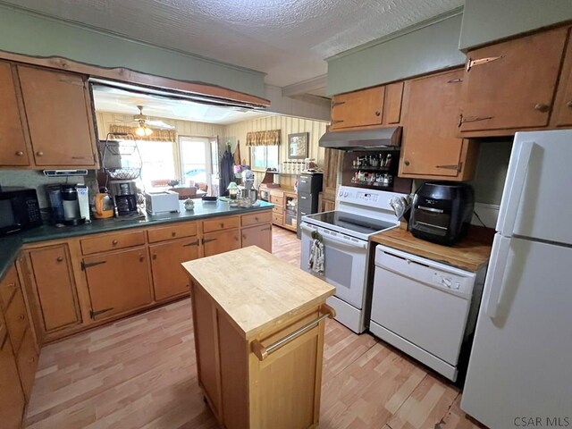 kitchen with ceiling fan, under cabinet range hood, butcher block countertops, light wood finished floors, and white appliances