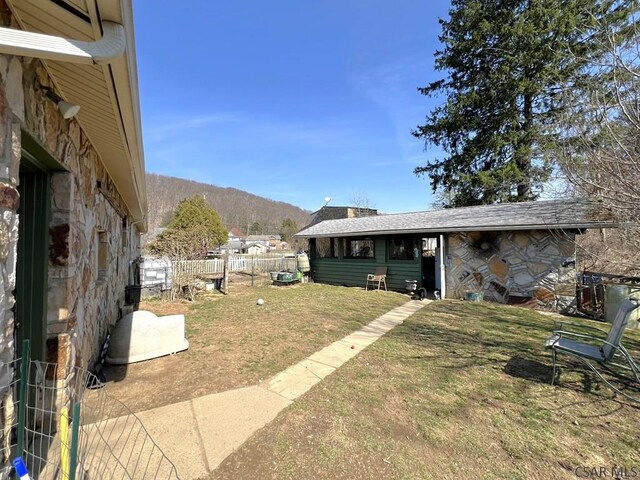 view of yard with a mountain view and fence