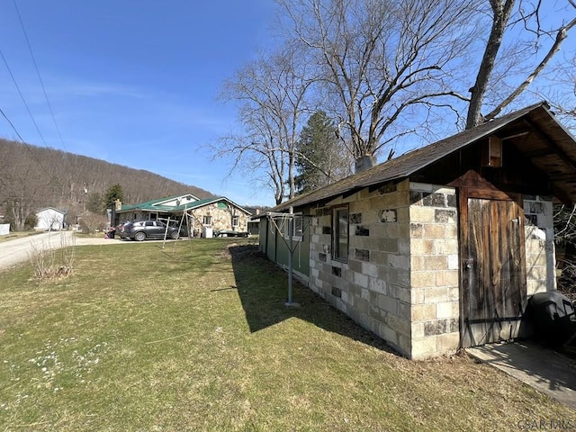 view of side of property featuring a yard
