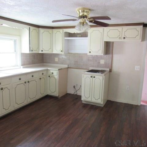 313 Dalton Run Rd, Johnstown, PA 15905 - kitchen featuring decorative backsplash, ceiling fan, dark wood-type flooring, light countertops, and a textured ceiling