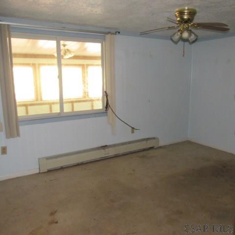 313 Dalton Run Rd, Johnstown, PA 15905 - spare room with baseboard heating and ceiling fan