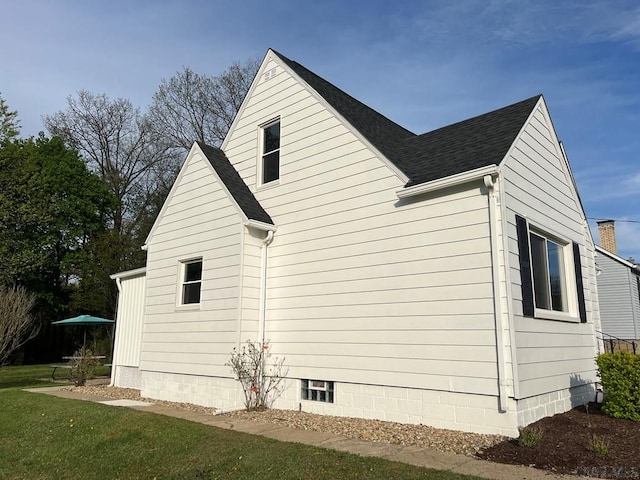 view of side of property featuring roof with shingles