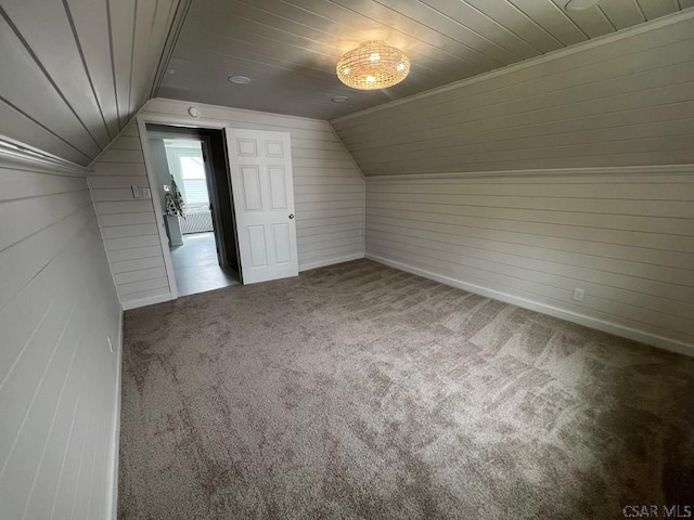 additional living space featuring vaulted ceiling, wood walls, carpet, and wooden ceiling