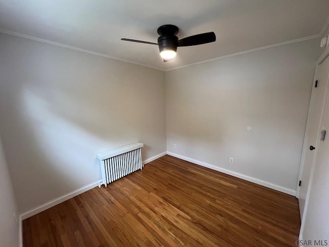 empty room with ceiling fan, crown molding, baseboards, and wood finished floors