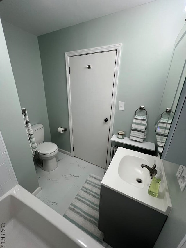full bath with vanity, toilet, and marble finish floor
