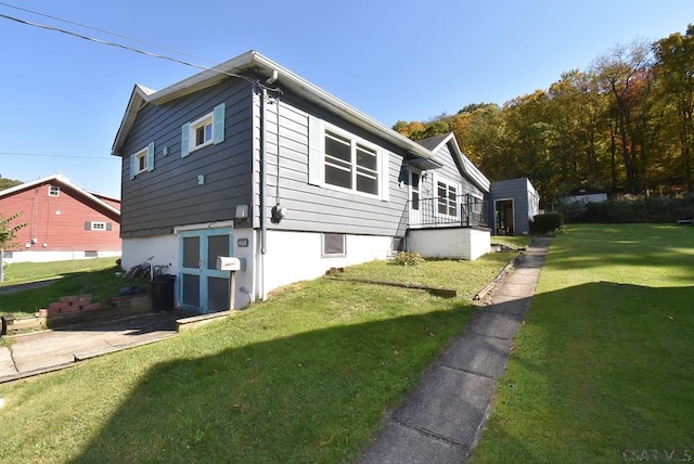 view of side of home with a yard