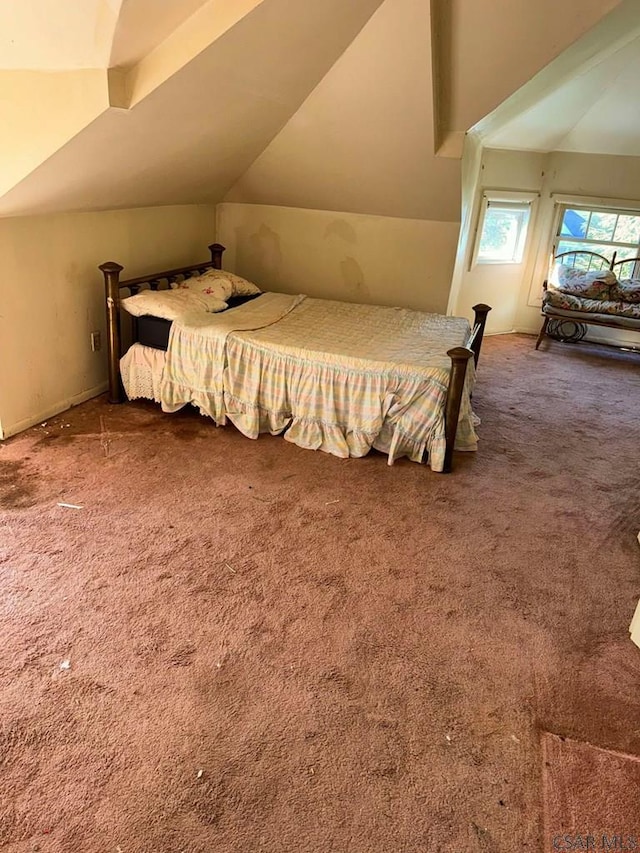 carpeted bedroom featuring lofted ceiling