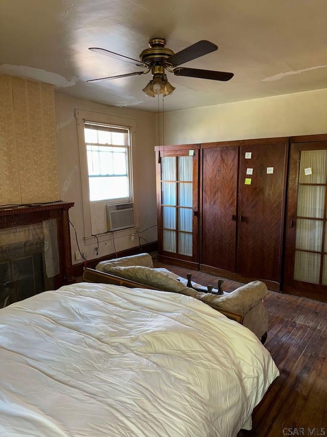 bedroom with cooling unit, hardwood / wood-style floors, and ceiling fan