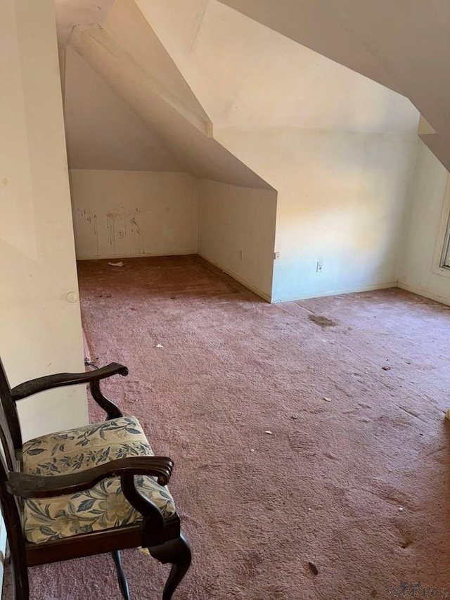 bonus room featuring light colored carpet and lofted ceiling