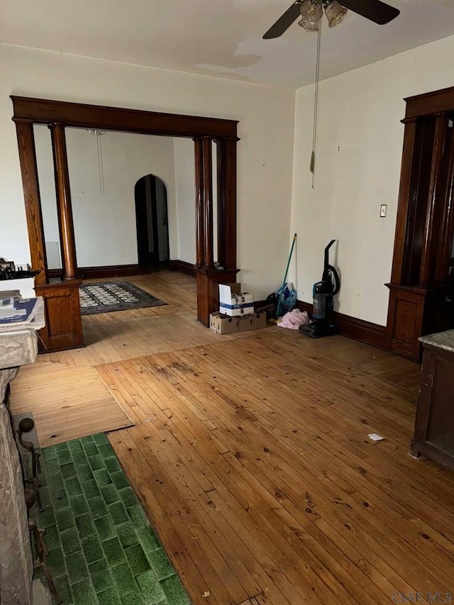 unfurnished living room featuring hardwood / wood-style flooring and ceiling fan