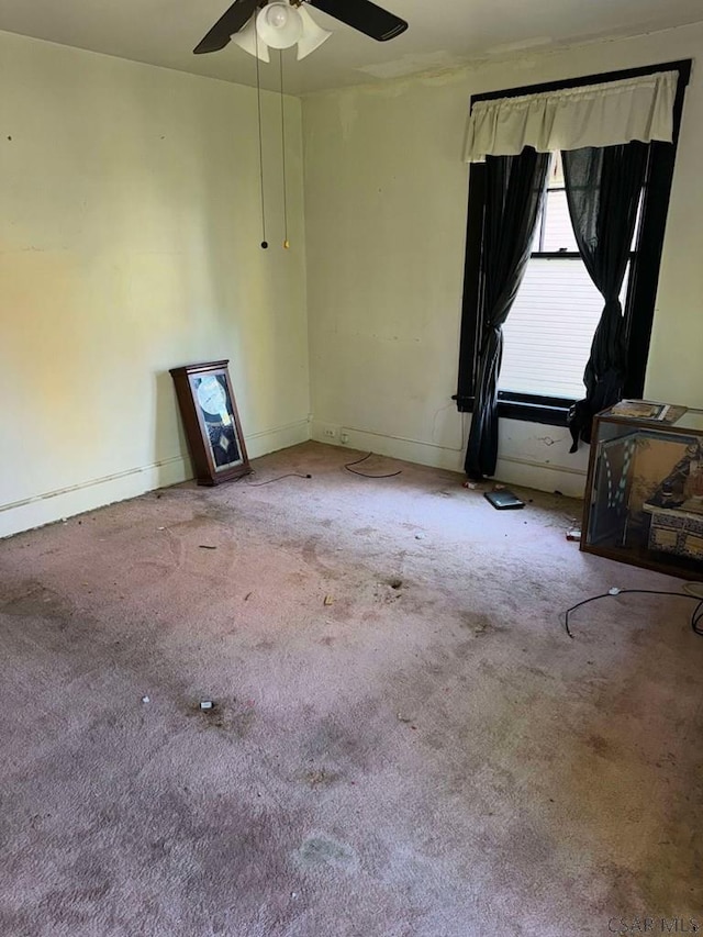 unfurnished room with ceiling fan and carpet floors