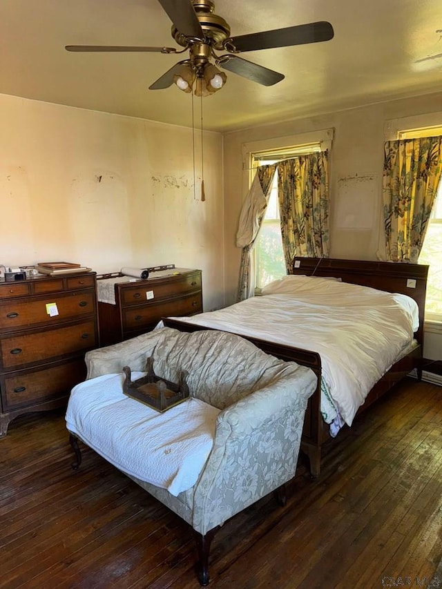 bedroom with dark hardwood / wood-style floors and ceiling fan