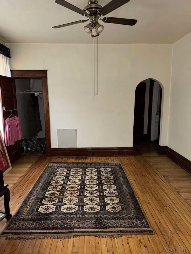 empty room featuring wood-type flooring and ceiling fan