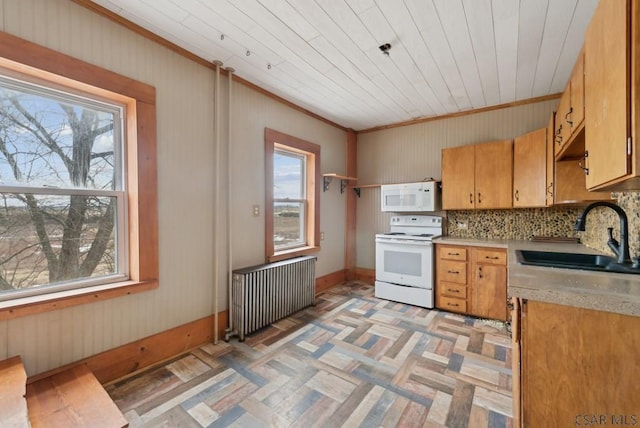 kitchen with sink, white appliances, radiator heating unit, ornamental molding, and decorative backsplash