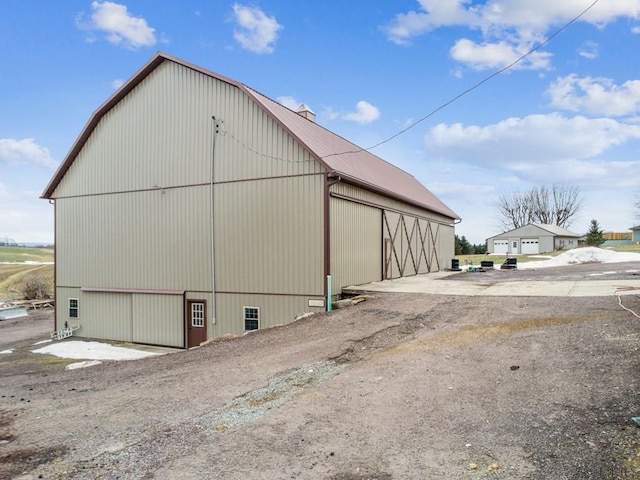 view of home's exterior featuring an outbuilding