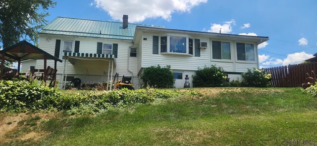 back of house featuring a yard