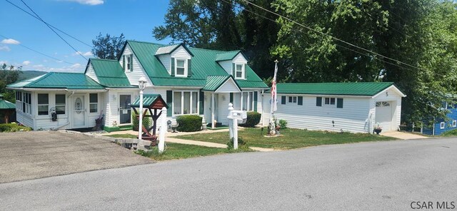 view of front of property featuring an outbuilding, a garage, and a front yard