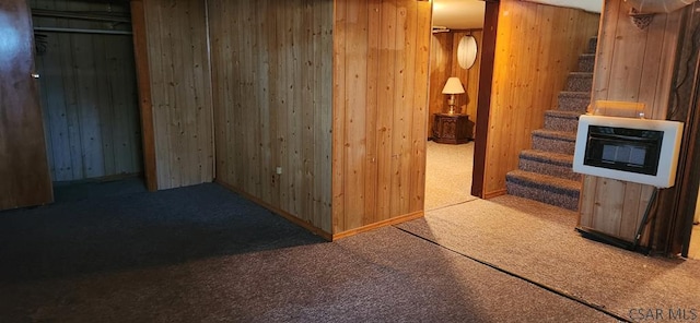 hallway with wooden walls and carpet floors