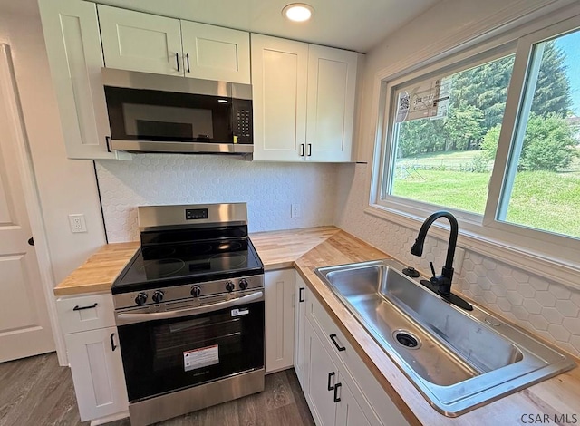 247 Jefferson Ave, Windber, PA 15963 - kitchen featuring appliances with stainless steel finishes, white cabinets, wooden counters, dark wood-style floors, and recessed lighting