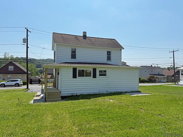 247 Jefferson Ave, Windber, PA 15963 - back of house with a yard and a chimney