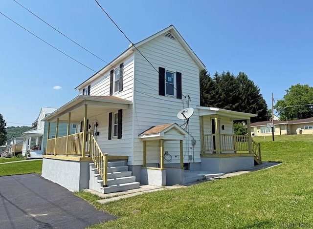 247 Jefferson Ave, Windber, PA 15963 - view of front of home featuring covered porch and a front lawn