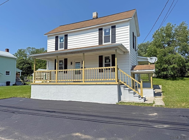 247 Jefferson Ave, Windber, PA 15963 - view of front of home featuring covered porch, a chimney, and a front lawn