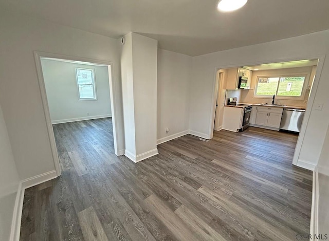 247 Jefferson Ave, Windber, PA 15963 - kitchen with stainless steel appliances, white cabinets, dark wood-style flooring, light countertops, and open floor plan