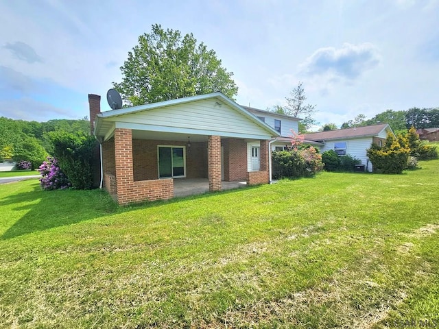 2139 Woodcrest Dr, Johnstown, PA 15905 - view of front of home with a chimney, brick siding, and a front lawn
