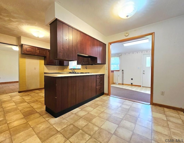 2139 Woodcrest Dr, Johnstown, PA 15905 - kitchen with a peninsula, light countertops, baseboards, and dark brown cabinetry