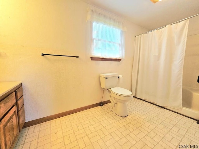 2139 Woodcrest Dr, Johnstown, PA 15905 - bathroom featuring brick patterned flooring, toilet, vanity, baseboards, and shower / tub combo