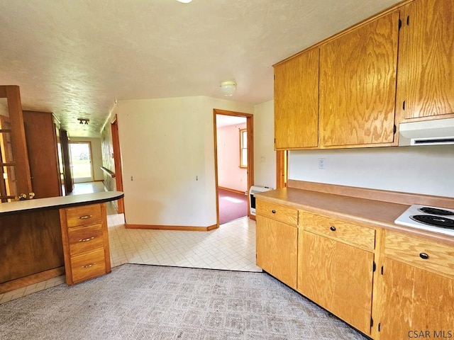 2139 Woodcrest Dr, Johnstown, PA 15905 - kitchen with exhaust hood, white electric stovetop, baseboards, light countertops, and a textured ceiling