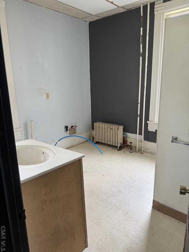 bathroom featuring radiator heating unit, tile patterned floors, and a sink