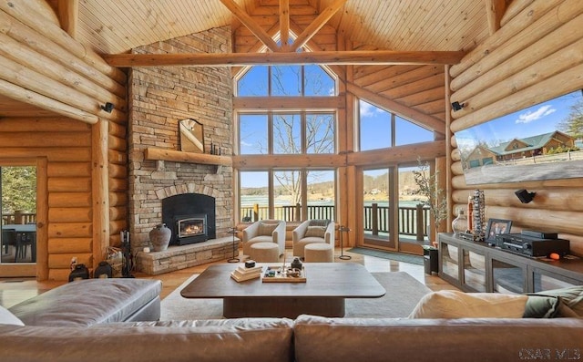 living room with wood finished floors, plenty of natural light, a fireplace, wooden ceiling, and beamed ceiling