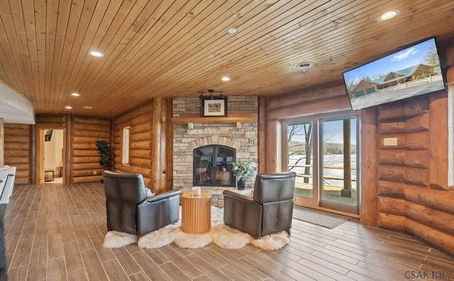 living room featuring a fireplace, recessed lighting, and wood tiled floor