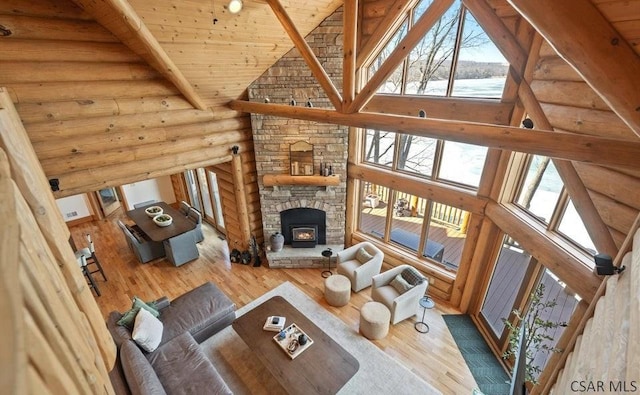 living area with beamed ceiling, wooden ceiling, high vaulted ceiling, and wood finished floors