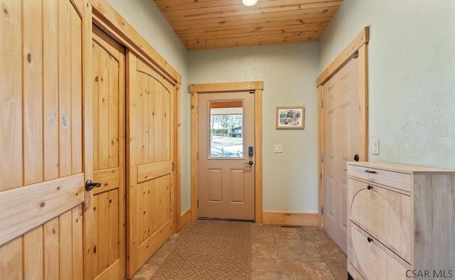 entryway with wood ceiling and baseboards
