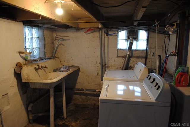 washroom featuring independent washer and dryer, sink, and a wealth of natural light