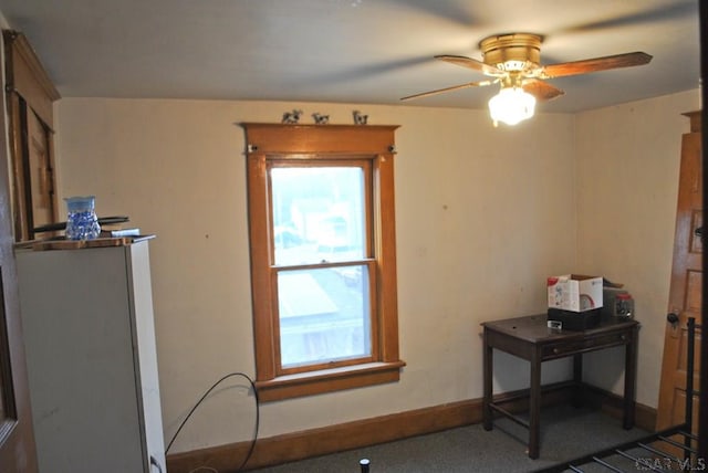 interior space with ceiling fan