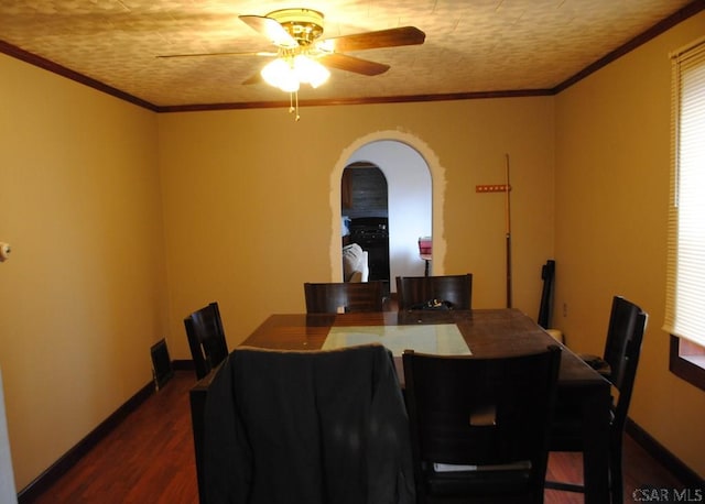 dining area featuring crown molding, dark wood-type flooring, and ceiling fan