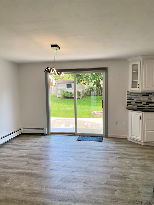 104 Erin Rd, Johnstown, PA 15905 - unfurnished dining area featuring wood finished floors, a chandelier, a baseboard radiator, and baseboards