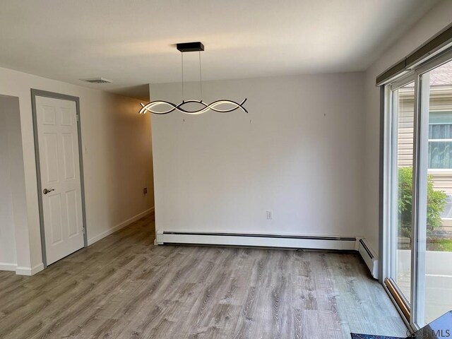 104 Erin Rd, Johnstown, PA 15905 - empty room with wood finished floors, plenty of natural light, a baseboard radiator, and baseboards