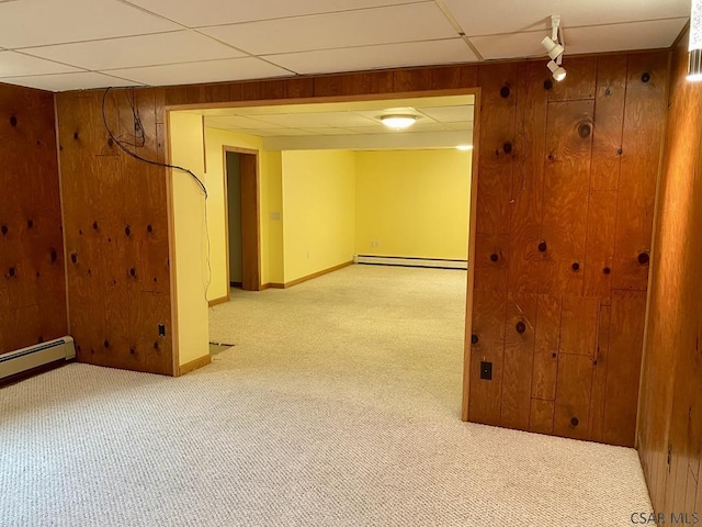 104 Erin Rd, Johnstown, PA 15905 - finished basement featuring a baseboard radiator, light colored carpet, wooden walls, baseboards, and a drop ceiling