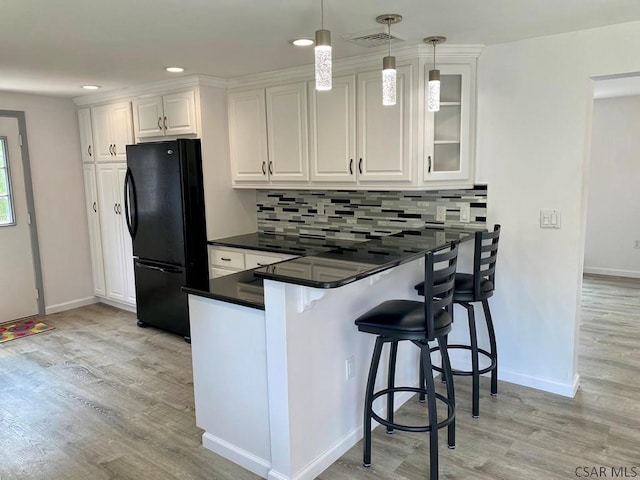 104 Erin Rd, Johnstown, PA 15905 - kitchen with freestanding refrigerator, white cabinetry, light wood-type flooring, a peninsula, and baseboards