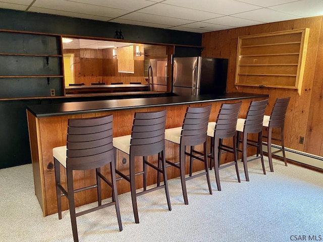 104 Erin Rd, Johnstown, PA 15905 - indoor wet bar with freestanding refrigerator, wood walls, and carpet floors