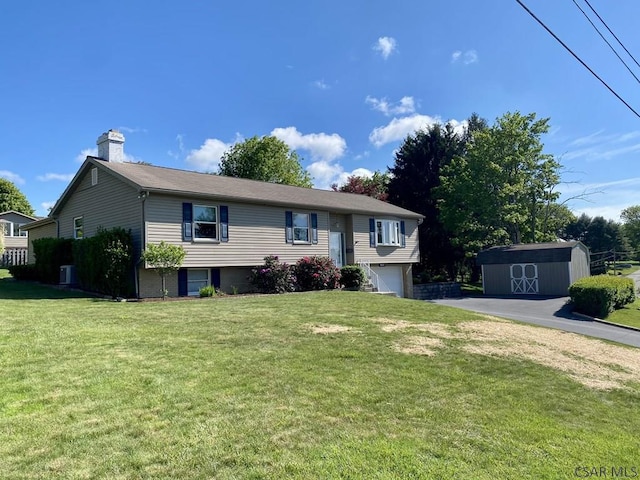 104 Erin Rd, Johnstown, PA 15905 - split foyer home featuring a chimney, a garage, and a front yard