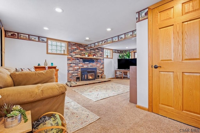 living room with carpet floors, a wood stove, baseboards, and recessed lighting