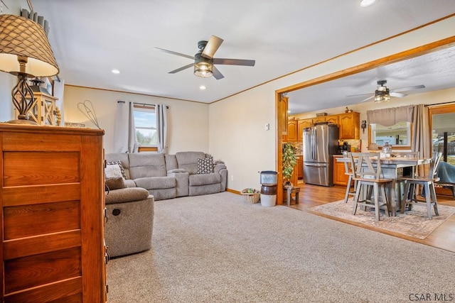 living area with baseboards, recessed lighting, a ceiling fan, and light colored carpet